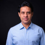 Portrait Of Indian Man Against Black Background